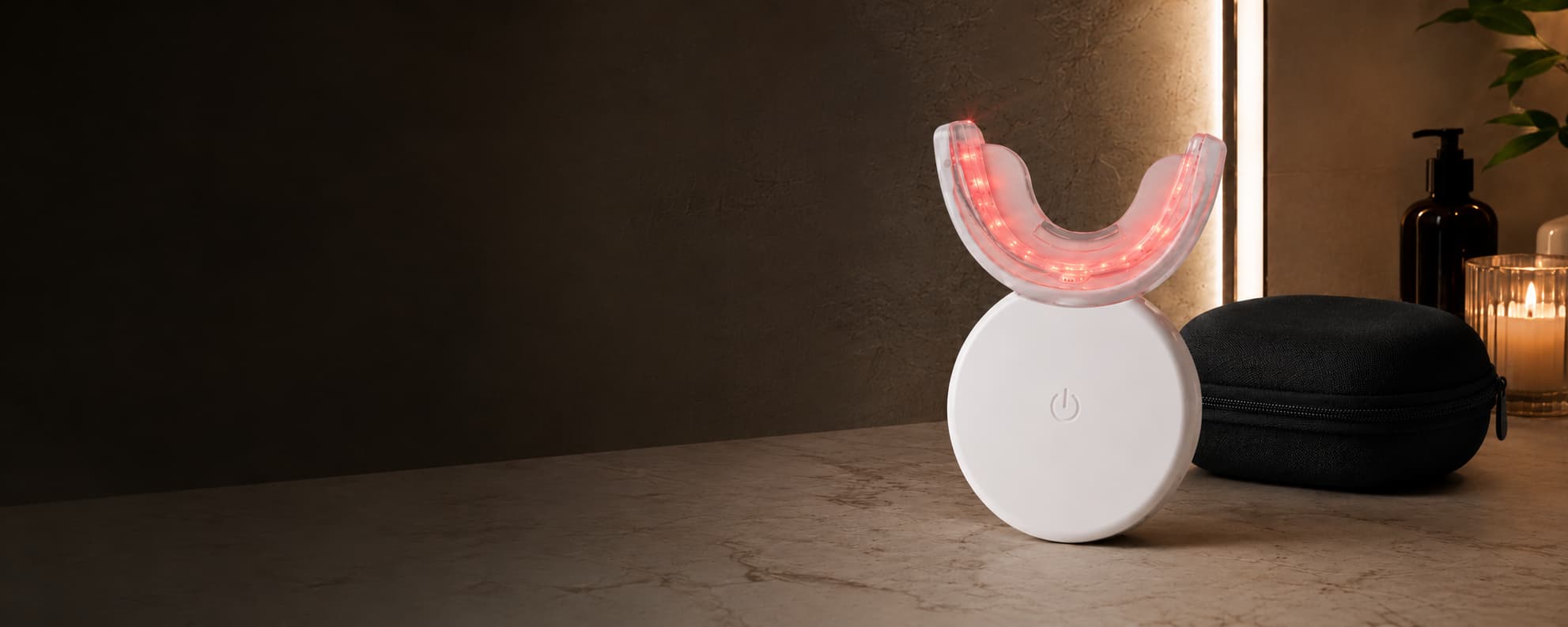 LED oral-care mouthpiece with charging case and USB-C cable on a bathroom counter